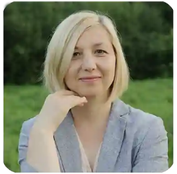 Middle aged woman smiling while reading small print comfortably in natural light